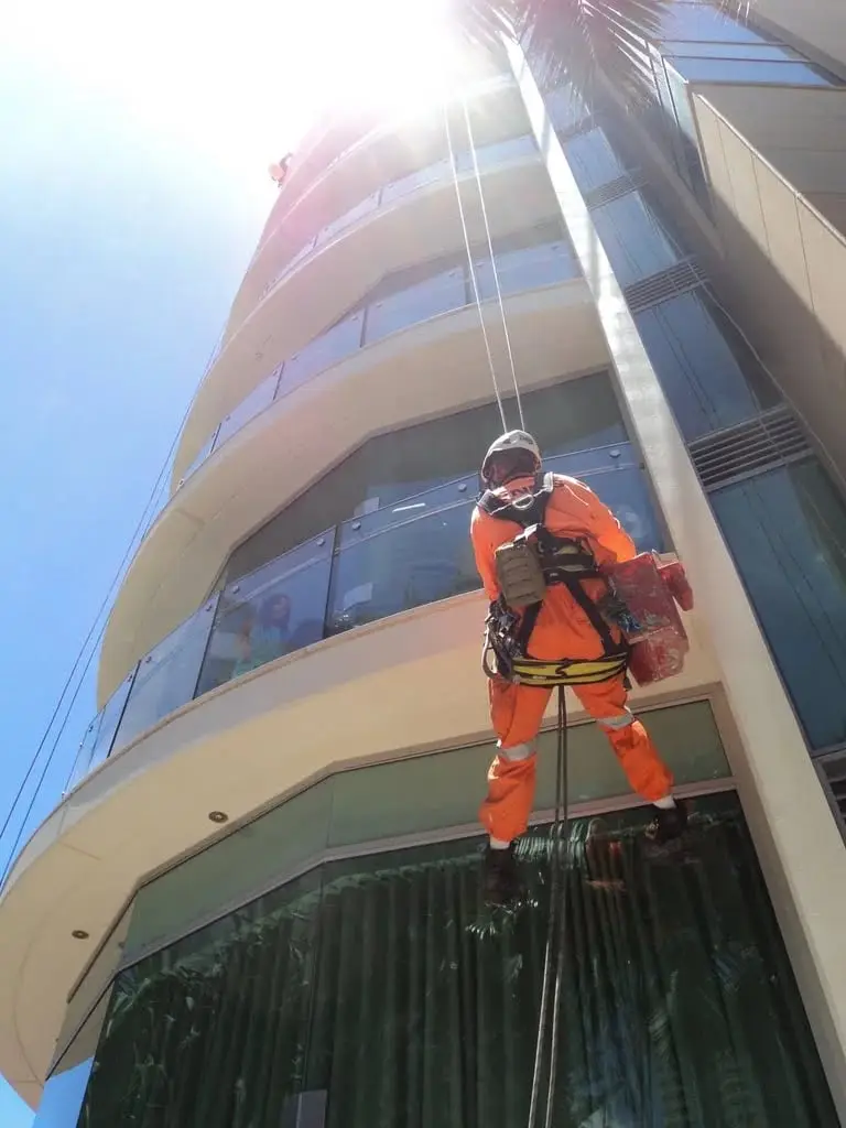 Descending a curved tower, Rope technician with a bucket.