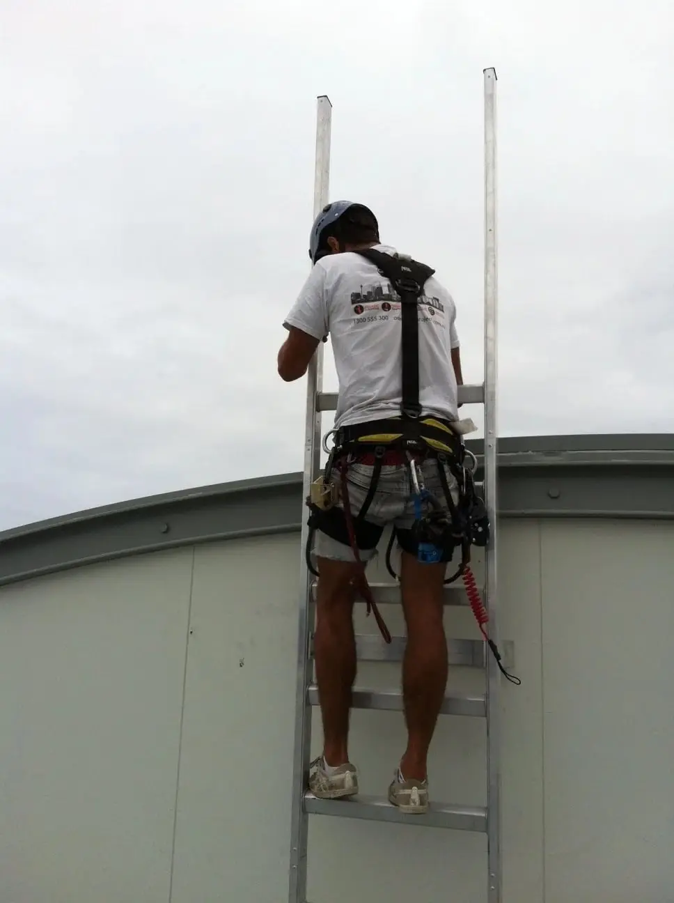 First climb, Harnessed technician on the ladder.