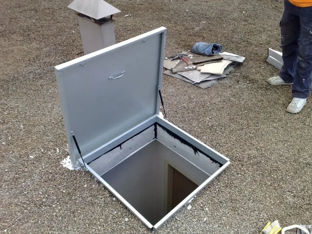 New roof hatch, Aluminium hatch open on a gravel roof.