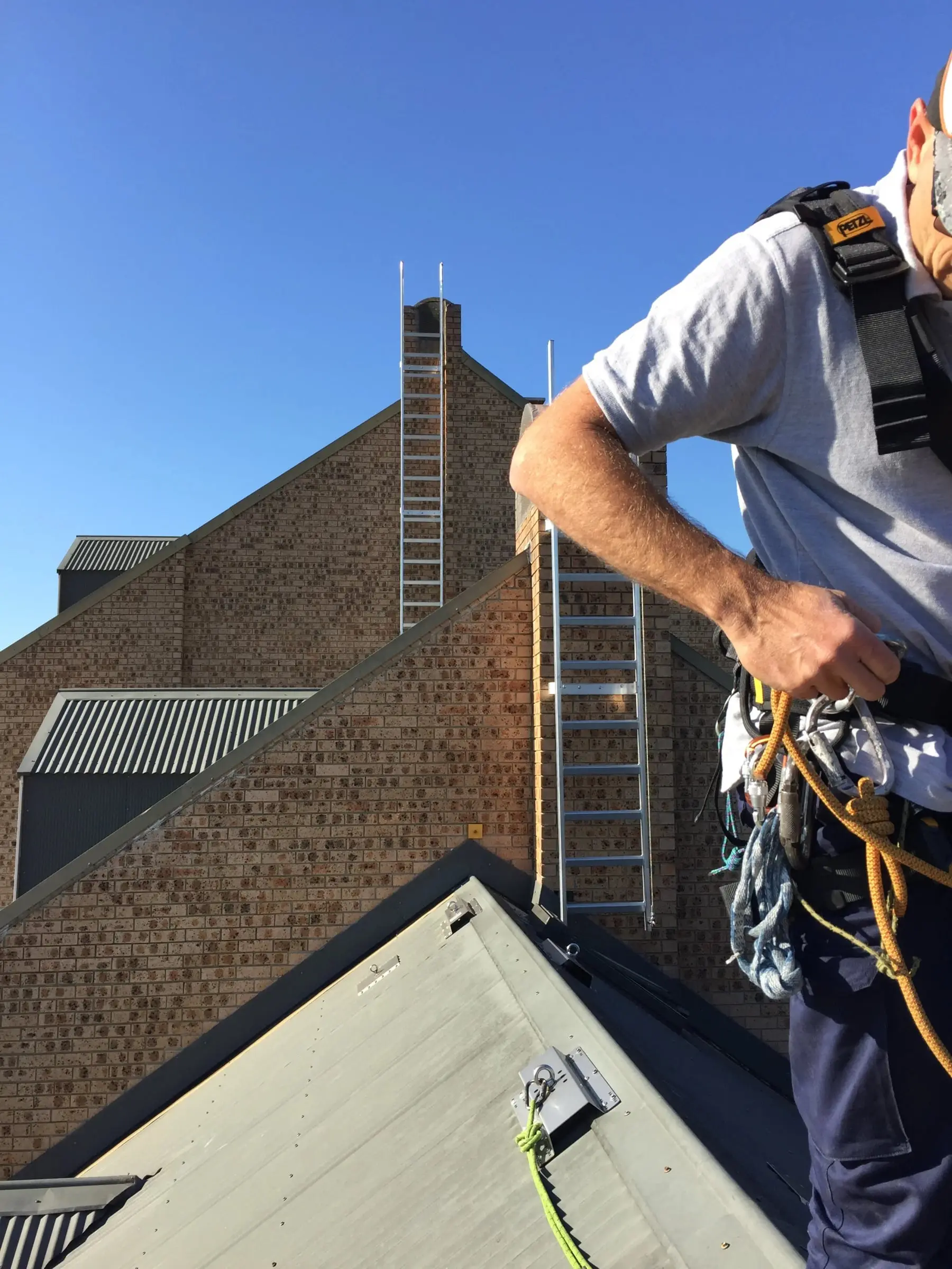 Ladders on a gable roof, Two new ladders up the brickwork.