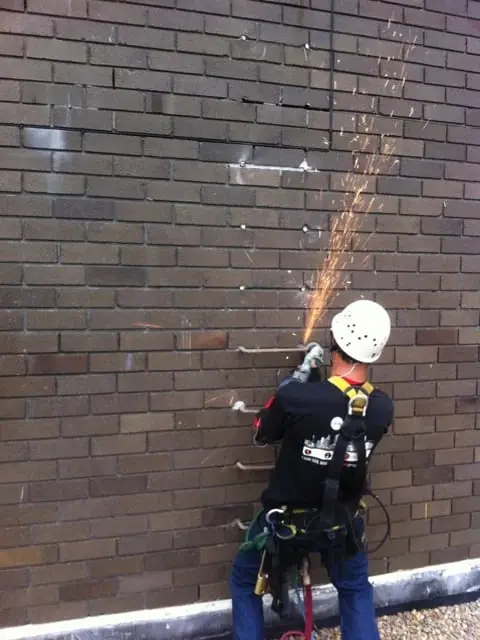 Cutting out old rungs, Technician grinding off the rungs.