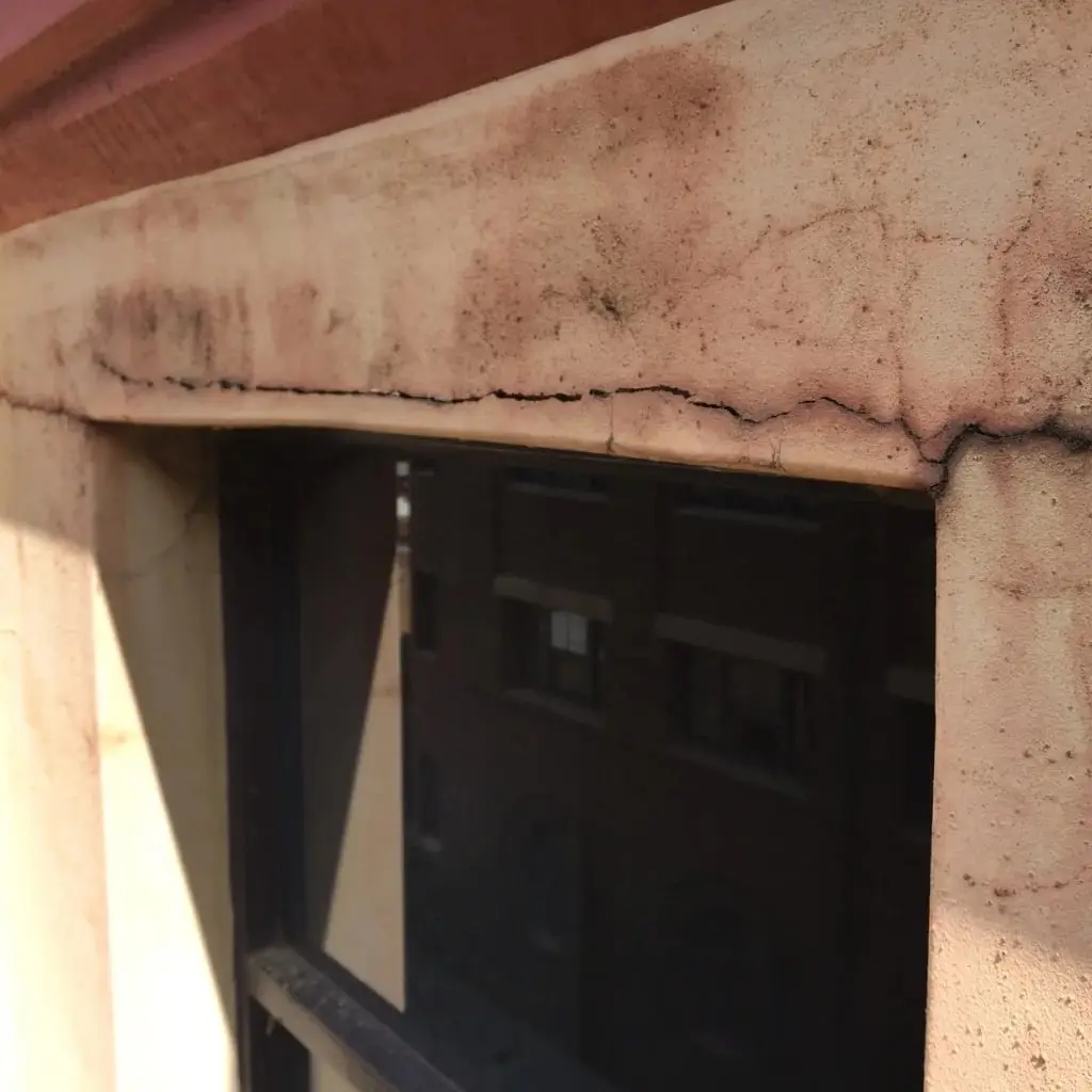 Cracked render above a window before lintel replacement, 330 Wattle St, Ultimo
