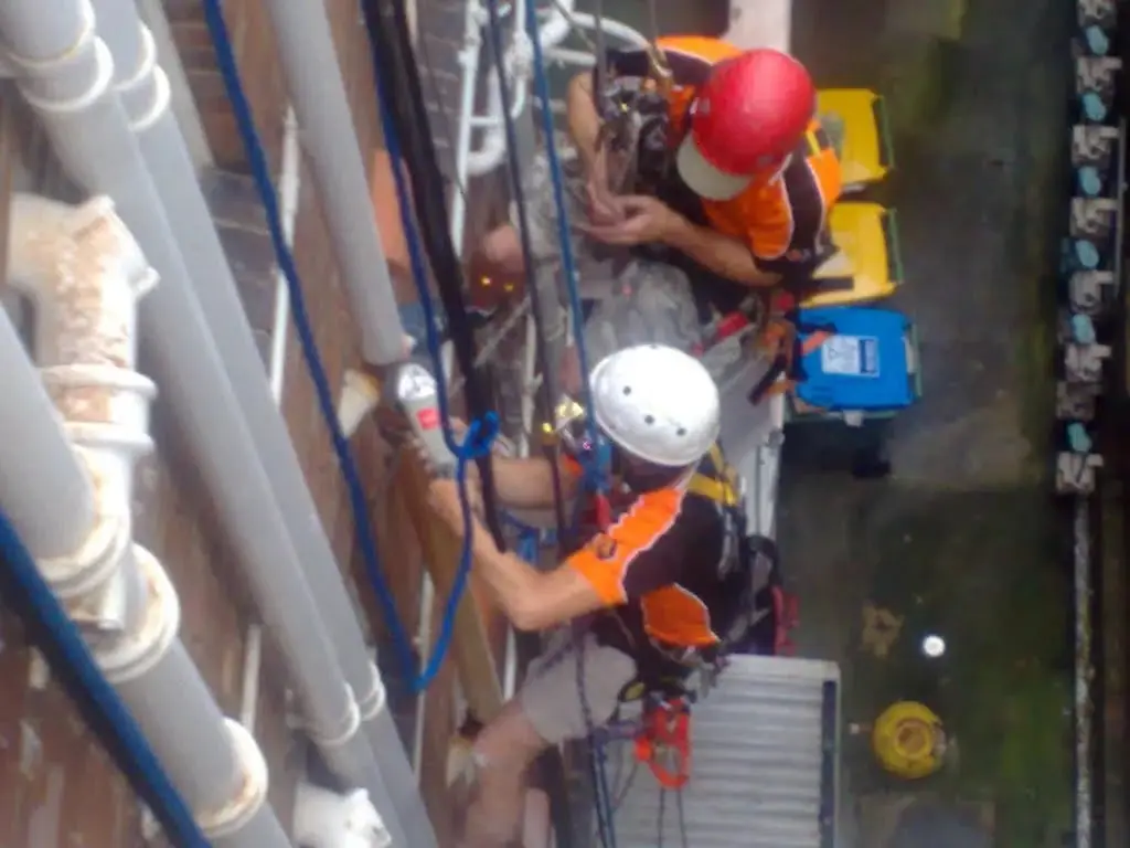 Two OneVision technicians on ropes replacing downpipes, Selsdon, Potts Point