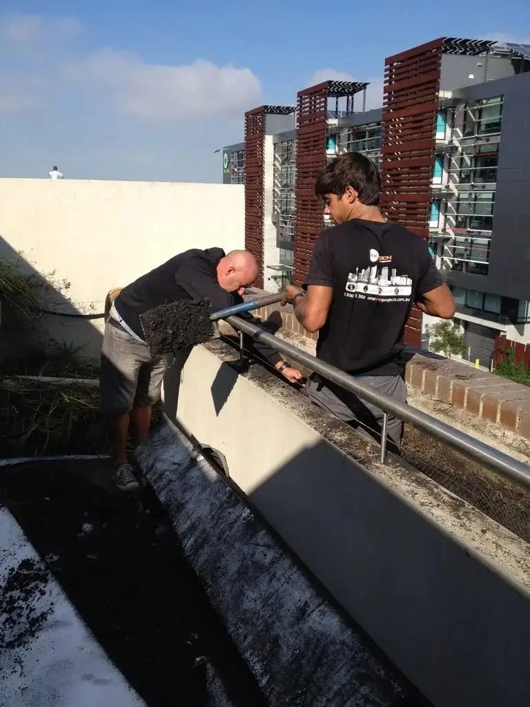 Removing soil from a planter box, Brooklyn, Cornwallis St · planter boxes