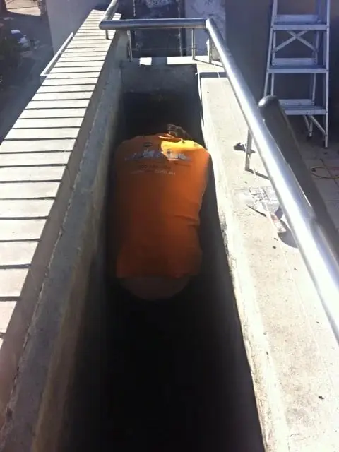 Grinding a planter box in a tight space, Brooklyn, Cornwallis St · planter boxes