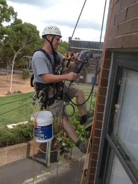 Repointing brickwork on ropes, Brooklyn, Cornwallis St · brickwork
