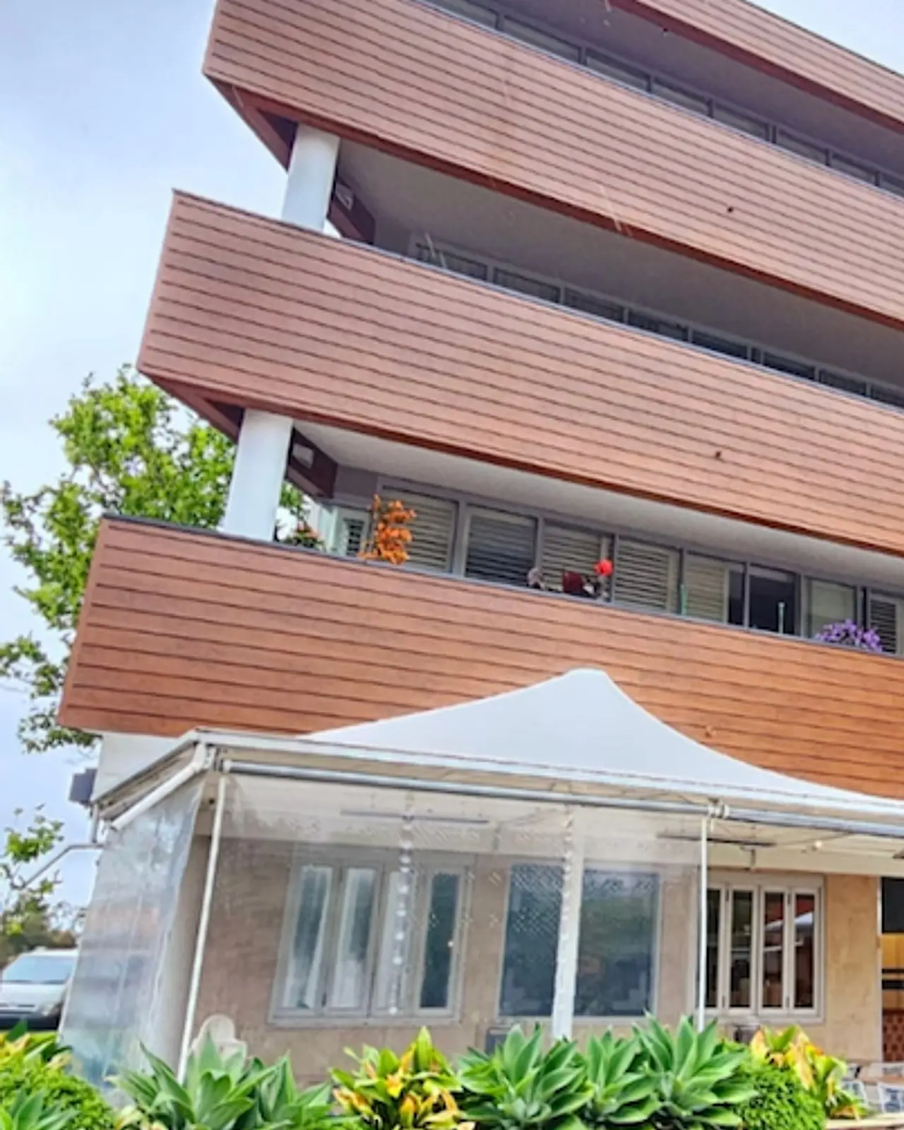 Building D at Cammeray Square finished: every balcony band clad in new timber-look cladding above the café