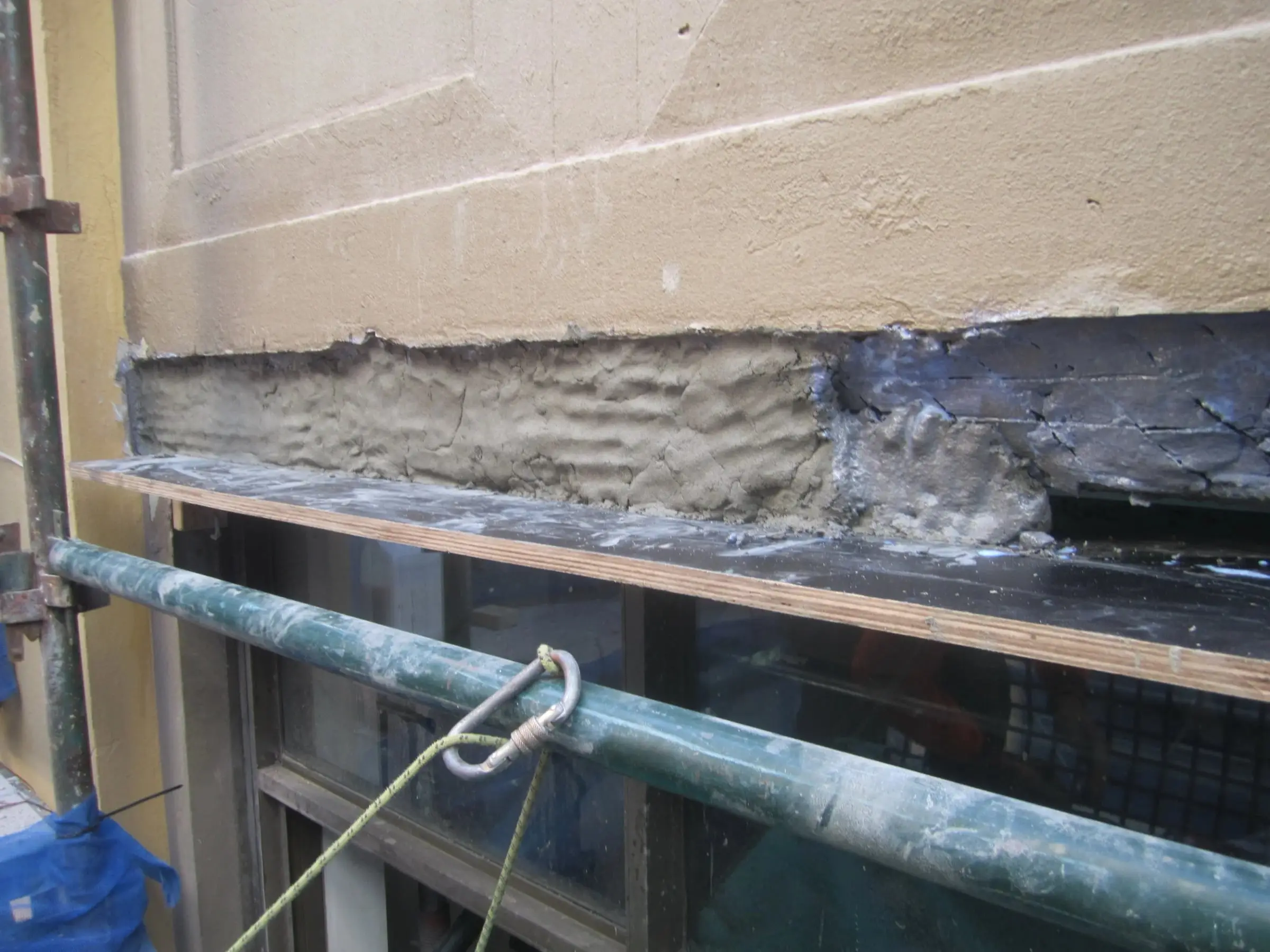 Concrete reinstated, Repair mortar built back along the beam, with a board fixed below as formwork.