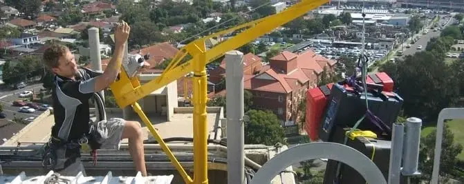 Rigging from a davit, Technician at a yellow davit arm.