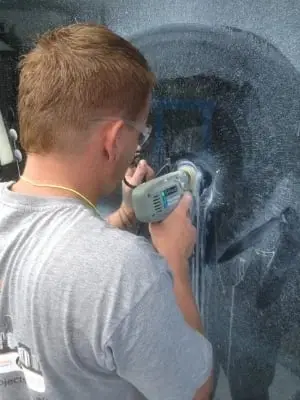 Machine polishing, Close-up of a technician buffing marks from glass with a polishing machine.