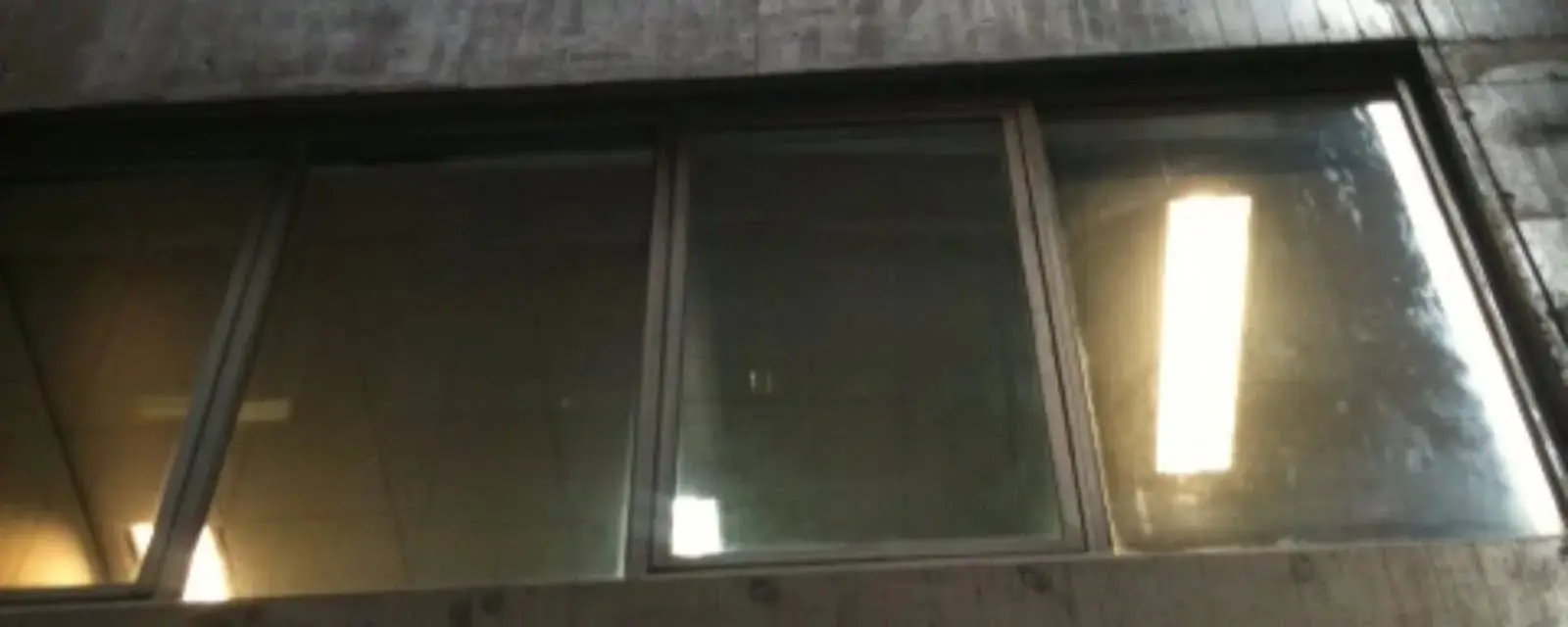 Calcium stains before, The same windows at 84 Pitt Street, Sydney, clouded with calcium staining before restoration.