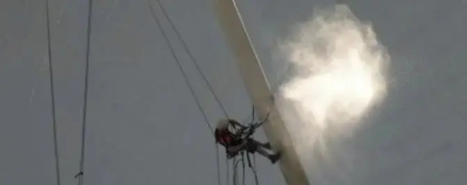 Washing at height, Spray rising from a technician on a tall mast.