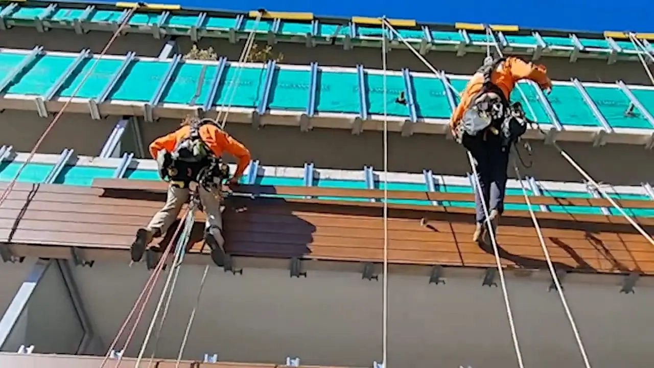 Video: Three technicians fixing cladding, Cammeray Square